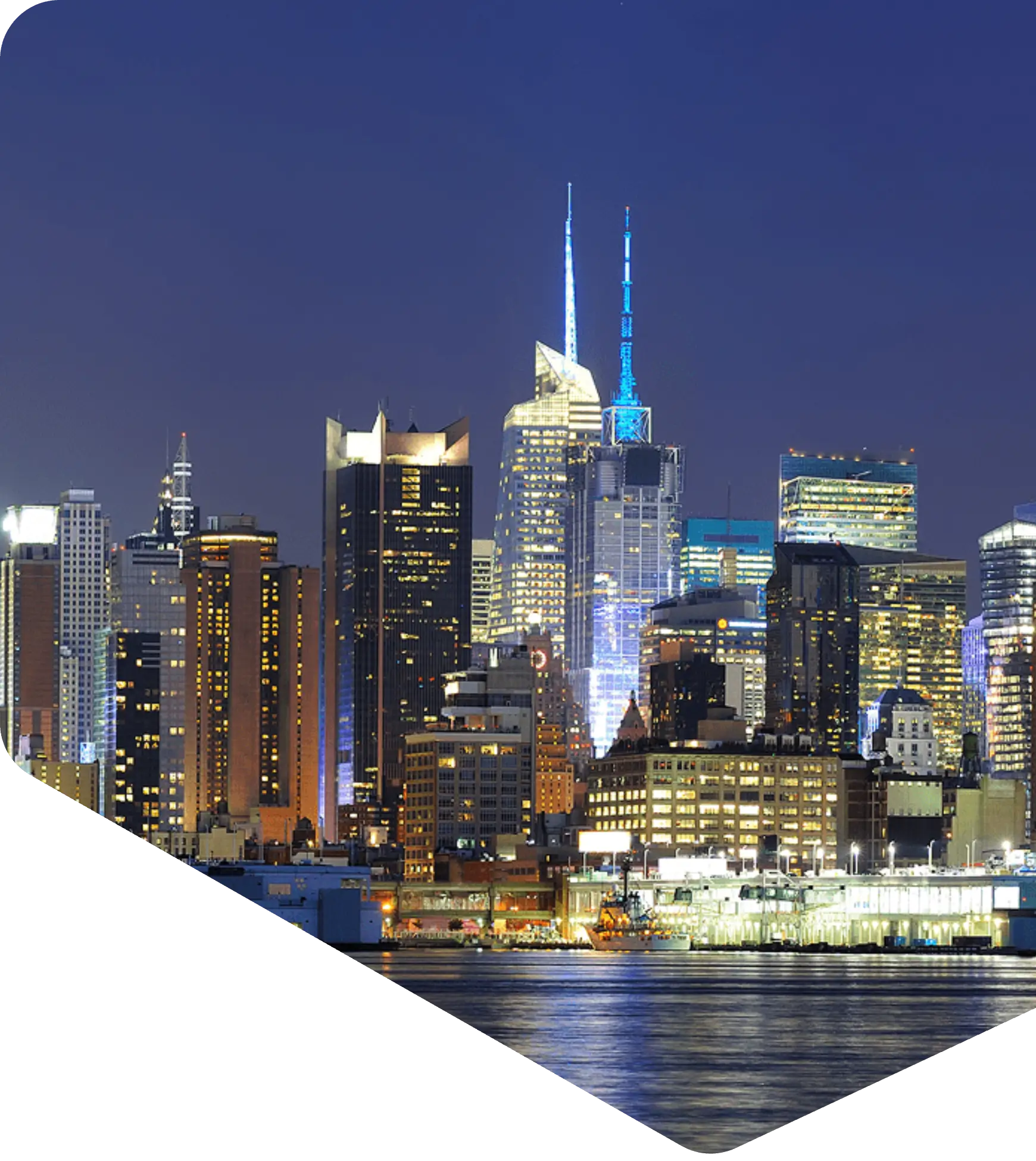 Blue-lit modern skyline reflecting on water